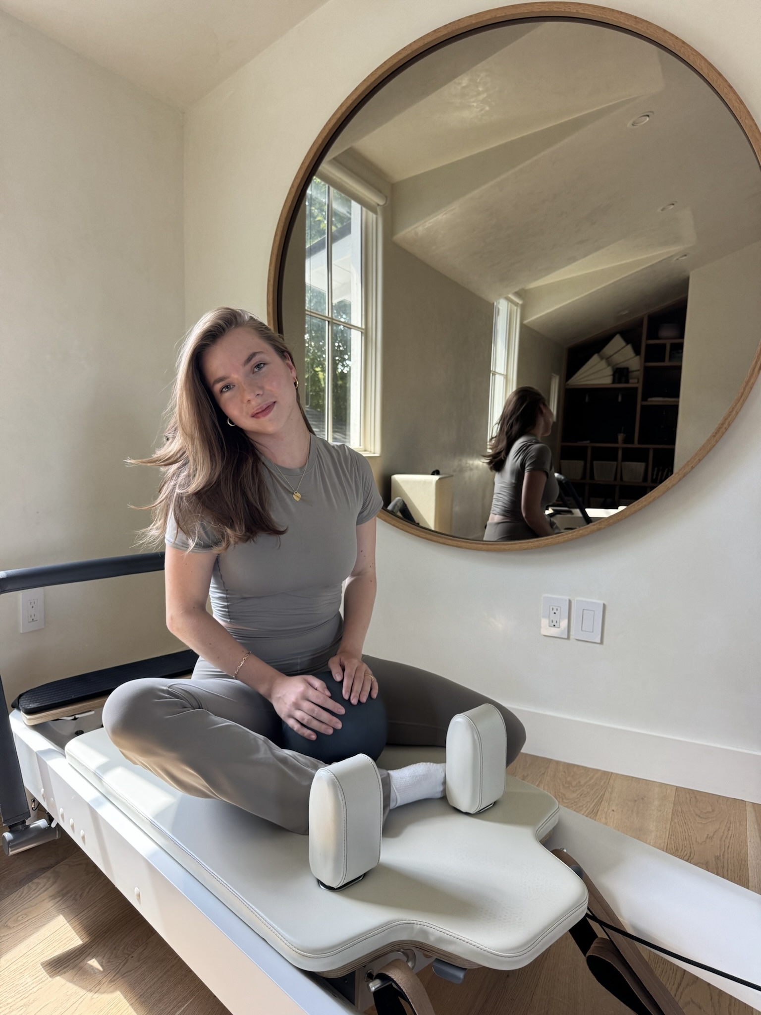 Victoria Puchkova teaching a Pilates reformer session in her Austin studio
